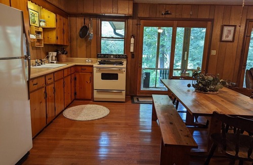 Harrisonville Cabin | Backyard creek, screened porch