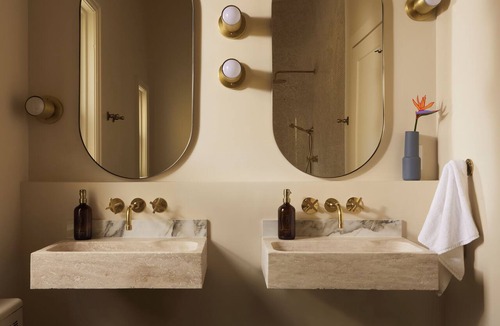 Stratford Hotel | This neutral flat packs a punch with a unique and interesting feature—a round king size bed!