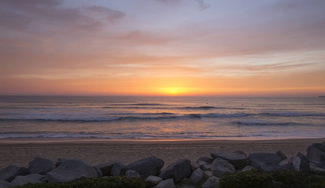 Relax on the deck patio or beach and watch the dolphins frolicking in the waves in Imperial Beach